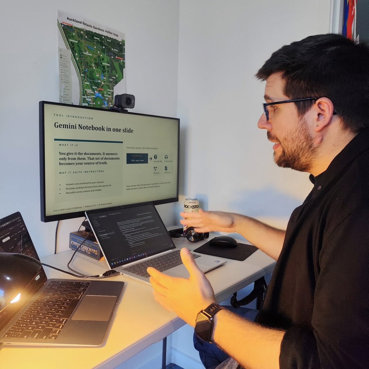 Dr Dmitry Zavialov delivering a workshop online from a desk with two screens