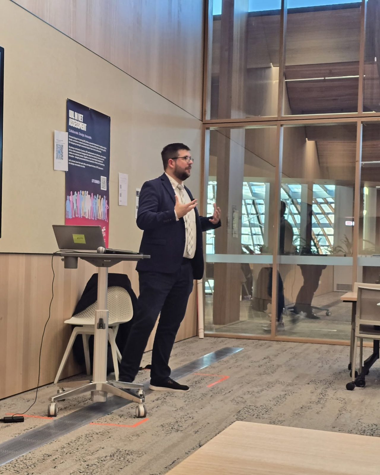Dr Dmitry Zavialov gesturing mid-talk at the ADCET Universal Design for Learning Symposium in Hobart